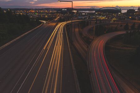 Long exposure shot of the highway near downtown Seattle, Washington in the late evening sunset with...