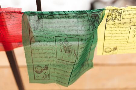 Green, yellow, and red Tibetan prayer flags.の写真素材