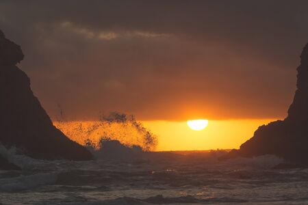 Rock formations at a rocky west coast beach at dusk.の写真素材