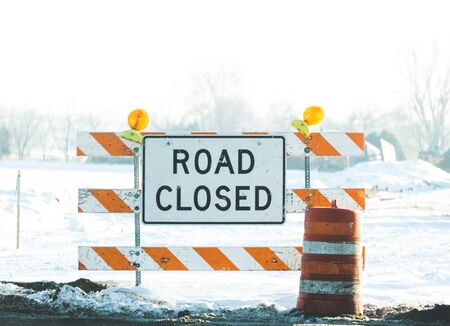 Road Closed sign on blockade in a construction zone in winter.の写真素材