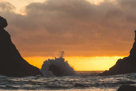 Rock formations at a rocky west coast beach at dusk.の写真素材