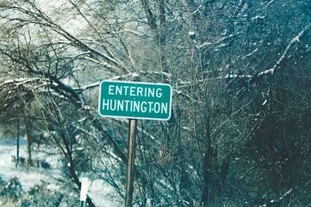 Road sign reading "Entering Huntington" in Oregon, USA. Winter setting.の写真素材