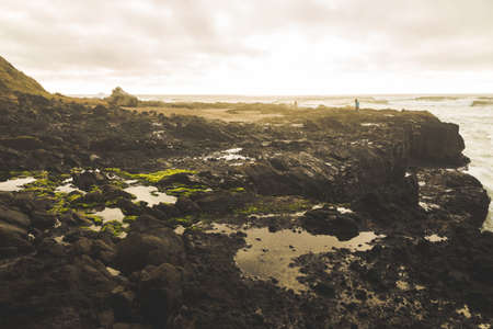 Jagged coastline under stormy skies.の写真素材