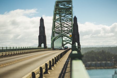 View from one end of a steel arch brigde with two towers.の写真素材