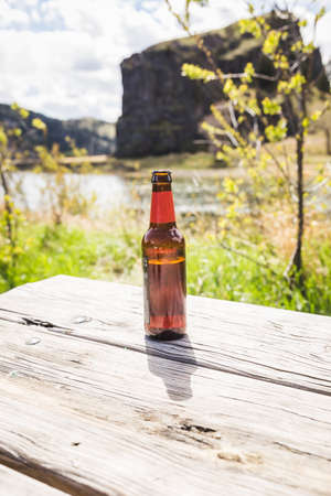 Beer on Table in Scenic Summer Settingの写真素材