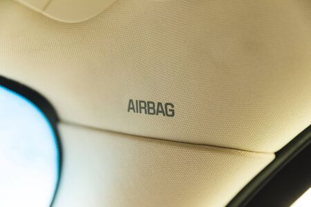 Airbag sign on the roof or pillar of a car interior.の写真素材