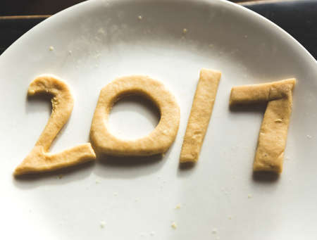 The year 2017 spelled out with cookie dough on a plate.