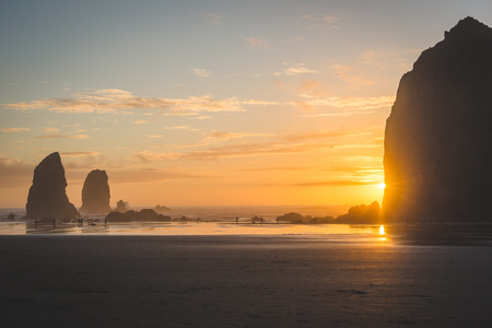 Beach area in front of Haystack Rock before sunset.の写真素材