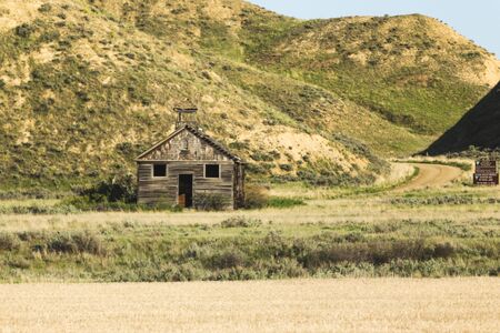 Abandoned wooden school house building in rural countryside. Central Montana, USA.の写真素材