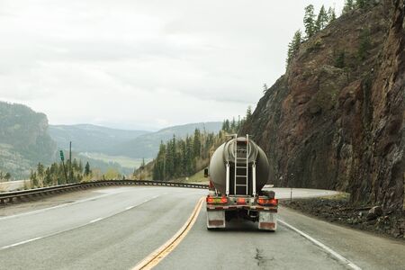 Cement truck on downhill grade in Rocky Mountain area highway.の写真素材