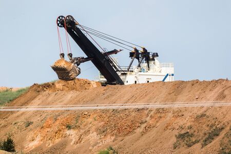 Heavy machinery working in a mine on a mountain ridge near Butte, Montana, USA.