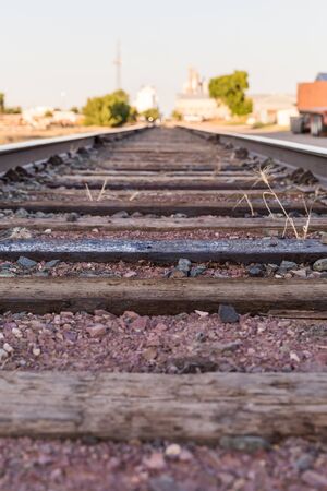 Details of railroad ties and ground. Train tracks in the industrial district of a town.の写真素材