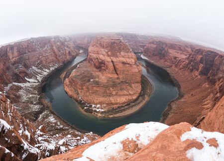 Horseshoe Bend in Paige, Arizona. Foggy winter day with snow on ground.の写真素材