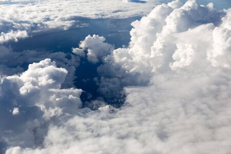 Puffy clouds seen from an airplane.の写真素材