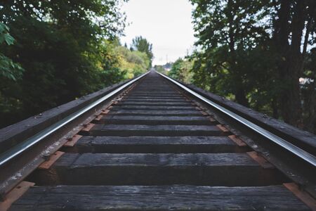 Train tracks and details of railroad ties in lush, green forest area. Newberg, Oregon, USA.の写真素材