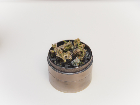 Steel grinder with green cannabis flower (buds) inside.の写真素材