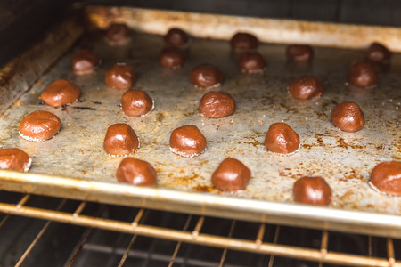 Raw chocolate cake balls in the oven, about to be baked.の写真素材