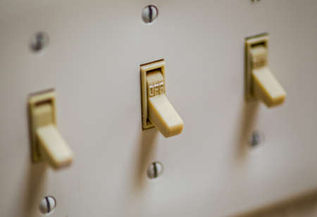 Closeup of old, standard light switches on a wall.の写真素材