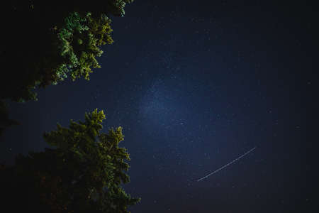 A meteor streaks across the star-filled sky during the Perseid Meteor Shower of 2021.の写真素材