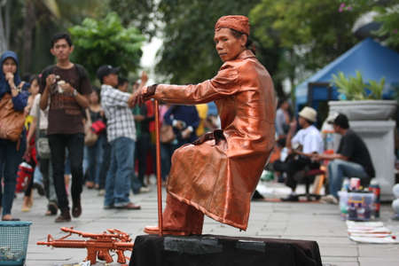 Jakarta, Indonesia. November 9, 2013: Attraction of the Human Statue as a general Soedirman (Indonesian hero) in the old city of Jakarta is an exhibition of street artists in the old city area.のeditorial素材