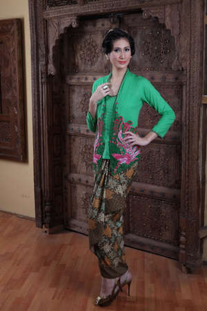 Beautiful woman wearing an elegant kebaya, kebaya is a traditional dress worn by Indonesian and Malaysian women made from gauze cloth worn with batik.の写真素材