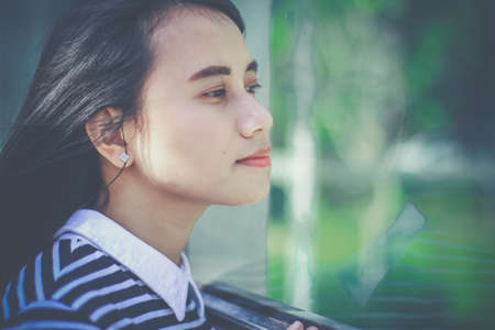 Casual business girl outside the office at glass wallの写真素材