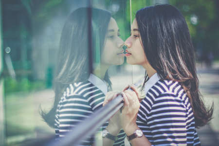 Casual business girl outside the office at glass wallの写真素材