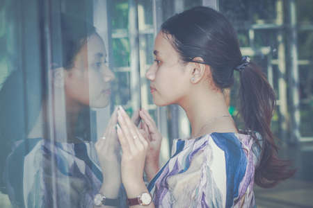 Casual business girl outside the office at glass wallの写真素材