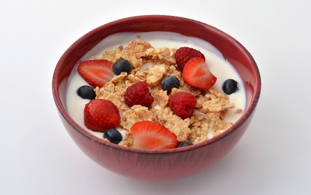 Breakfast bowl with yogurt, cereal, strawberries, blueberries and rasperries