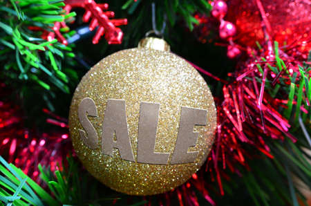 Golden Christmas ball with sale written on itの写真素材