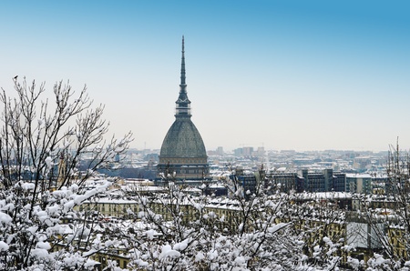Turin, Italy, in winter  Snow covered roofs and Mole Antonellianaの写真素材