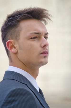 Profile portrait of attractive young businessman in suitの写真素材