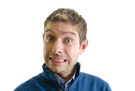 Handsome young man isolated on white making a funny faceの写真素材