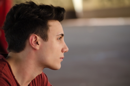 Attractive young man's side view portrait. Profile shot, outdoorsの写真素材