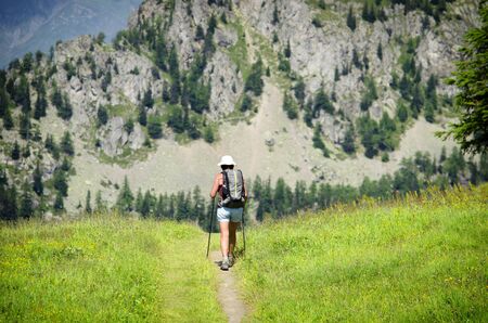 Woman or girl walking in the mountains, healthy trekkingの写真素材