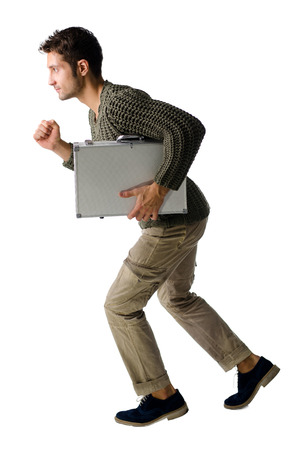 Attractive young man with briefcase running, isolated on white backgroundの写真素材