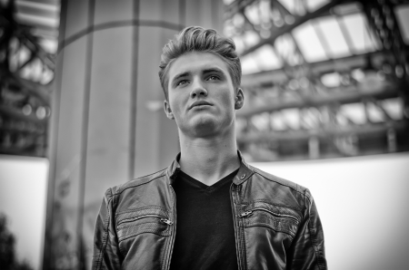 Attractive blond young man in city environment, black and white shotの写真素材