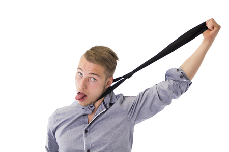 Funny young man hanging himself with neck-tie and sticking out tongueの写真素材