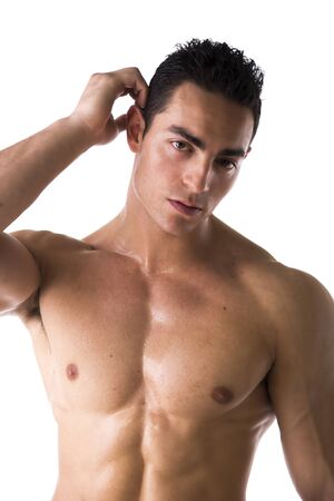 Muscular shirtless young man unsure or confused, scratching head with fingerの写真素材
