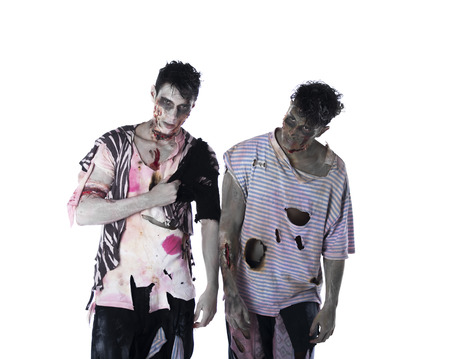 Two male zombies standing isolated on white background, looking at cameraの写真素材