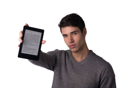 Handsome young man holding ebook reader and looking at camera, isolated on white backgroundの写真素材