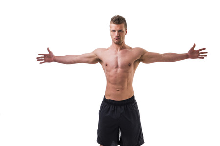 Attractive young muscle man shirtless with arms spread open, isolated on whiteの写真素材