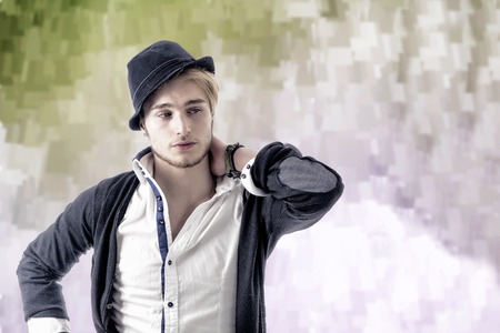 Portrait of handsome blond young man, blue eyes, on colorful abstract background