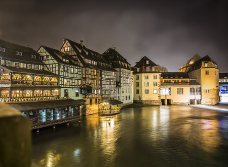 Scenic view View on river in Strasbourg, France at night. Romantic lights reflecting on the water...