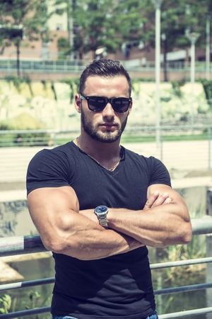 Handsome Muscular Hunk Man Outdoor in City Setting. Showing Healthy Body While Looking at Cameraの写真素材