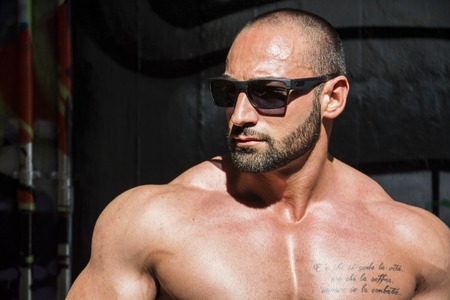 Handsome Muscular Shirtless Hunk Man Outdoor in City Setting. Showing Healthy Body While Looking awayの写真素材