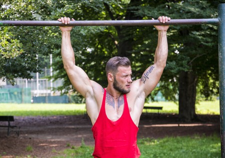 Handsome Muscular Hunk Man Outdoor in City Setting. Showing Healthy Body While Looking Away, Hanging...