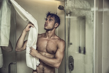 Close up Attractive Young Bare Muscular Man after Taking Shower, Grabbing Towelの写真素材