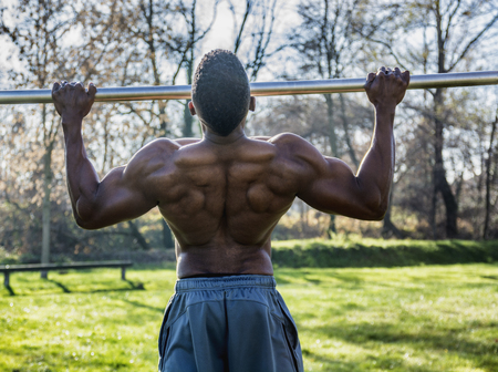 Muscular Shirtless Hunky Black Man Outdoor in City Park. Showing Healthy Muscle Body While Looking...