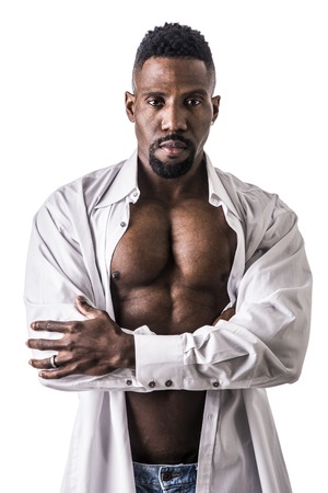 African American bodybuilder man, wearing jeans and open shirt on naked muscular torso, isolated on white backgroundの写真素材